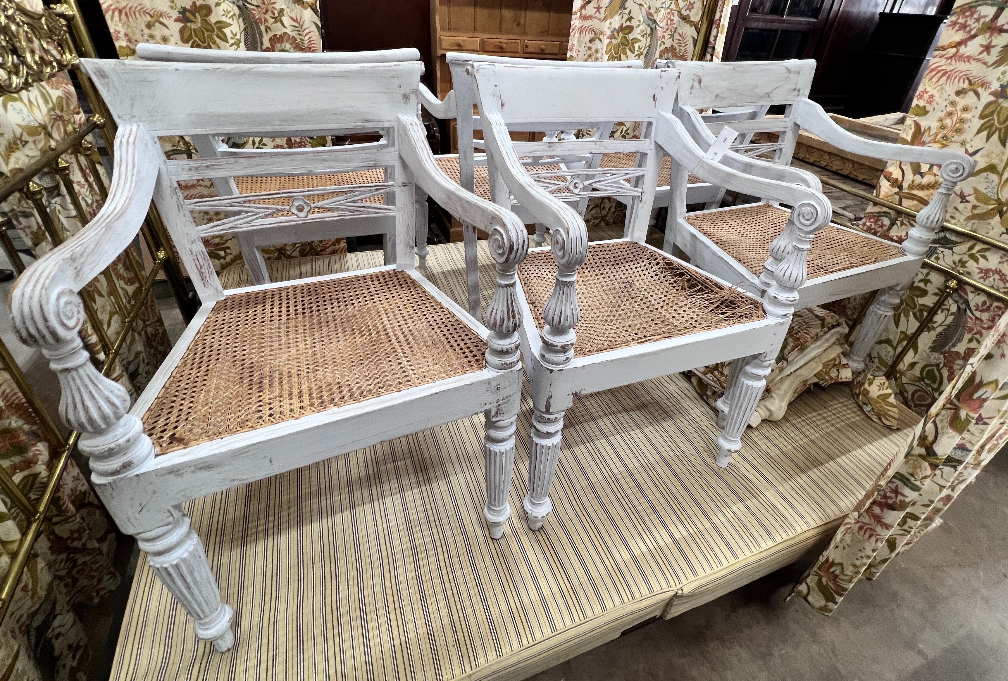 A set of six painted Indonesian hardwood cane seat elbow chairs, width 52cm, depth 45cm, height 84cm